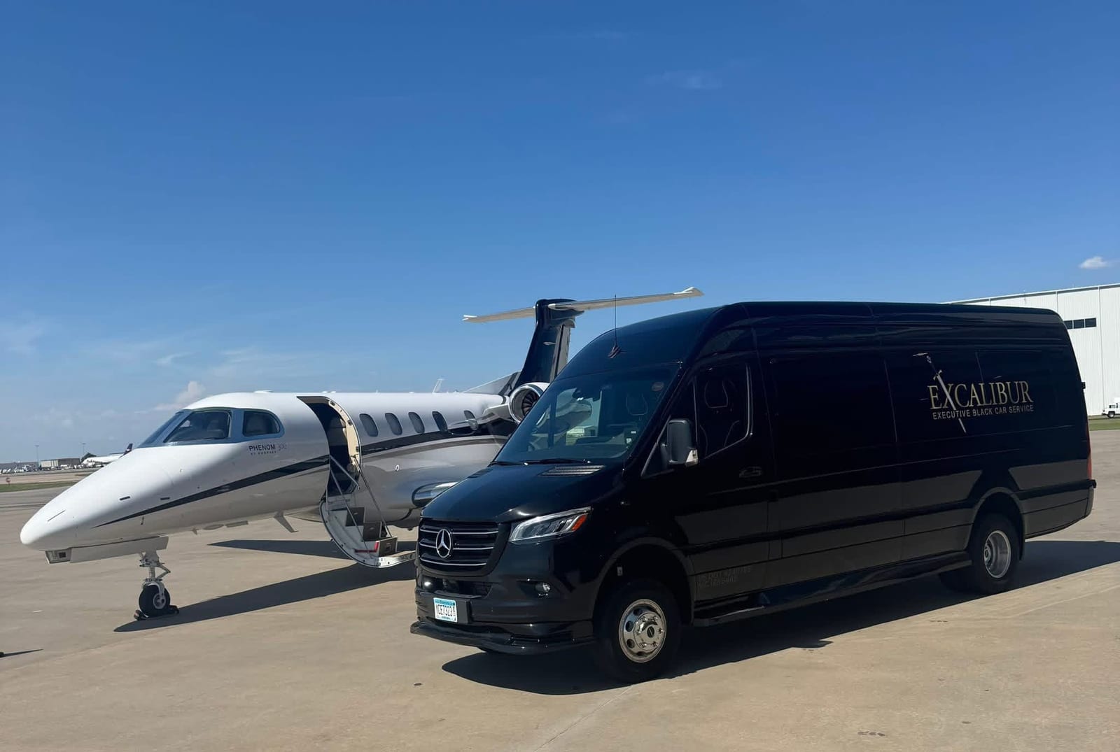 The Lancelot — matte black Mercedes-Benz Jet Sprinter parked under a building canopy, Excalibur Executive Black Car Service, Oklahoma City